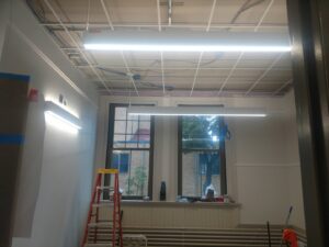 New commercial LED lighting fixtures installed on a ceiling grid by Icon West Corporation Electrical Contractors in Springfield, MA.