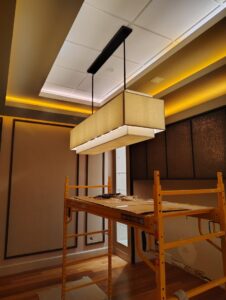 Installation of a large commercial light fixture using scaffolding, performed by Envision Electrical Solutions in Fort Lauderdale, FL.