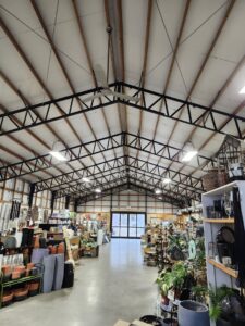 Commercial lighting and ceiling fan installation in a large retail space by ABS Electrical Services in Rogers, AR.