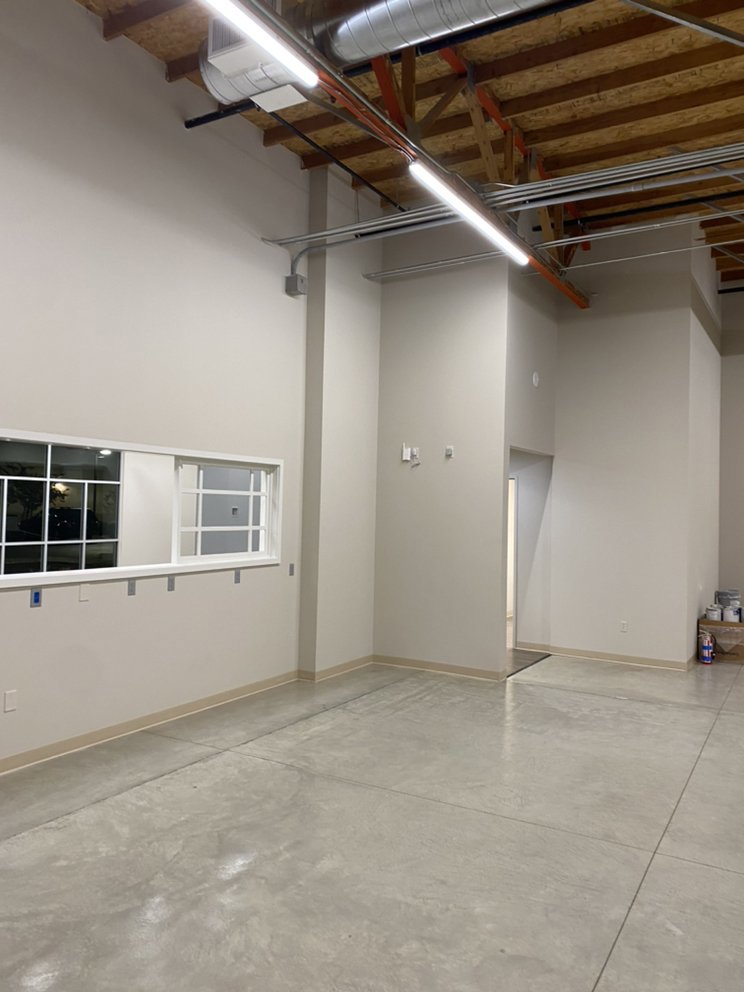 Commercial space with exposed conduit and fluorescent lighting installed by CLB Electric Corporation in Norwalk, CA