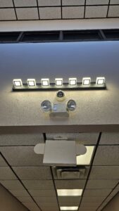 Commercial lighting, emergency light, and security camera installed on a ceiling by V Electrical LLC in Albuquerque, NM.