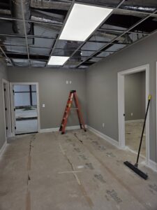 New commercial ceiling lights installed in a room under construction by Apex Electric LLC in Brea, CA.