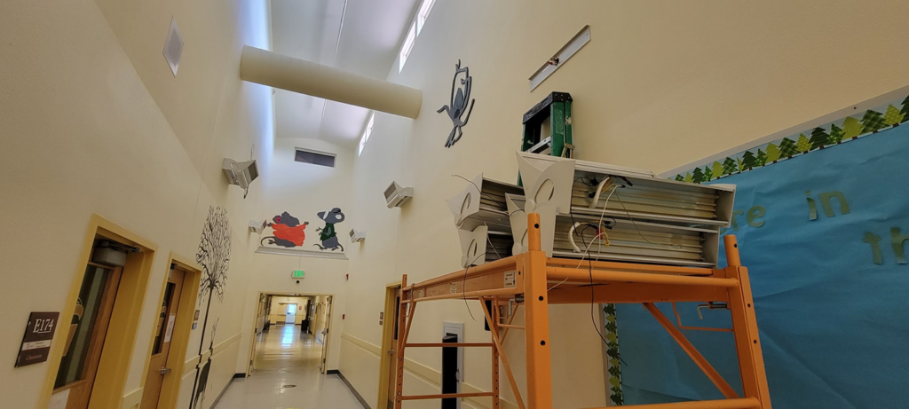 Commercial lighting installation and wiring work in progress on scaffolding by Bohan Electrical in Bella Vista, AR.