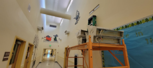 Commercial lighting installation and wiring work in progress on scaffolding by Bohan Electrical in Bella Vista, AR.