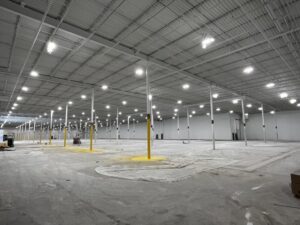 Commercial lighting installation in a large warehouse space by Empower Electrical, LLC in Fall River, MA