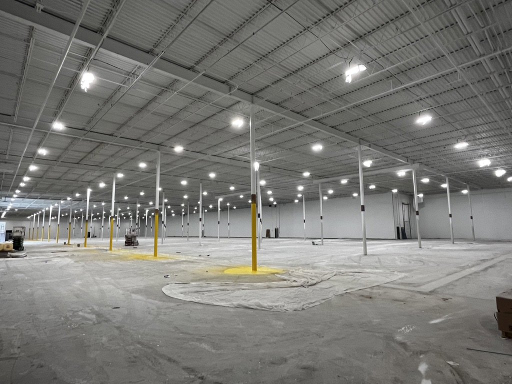 Commercial lighting installation in a large warehouse space by Empower Electrical, LLC in Fall River, MA