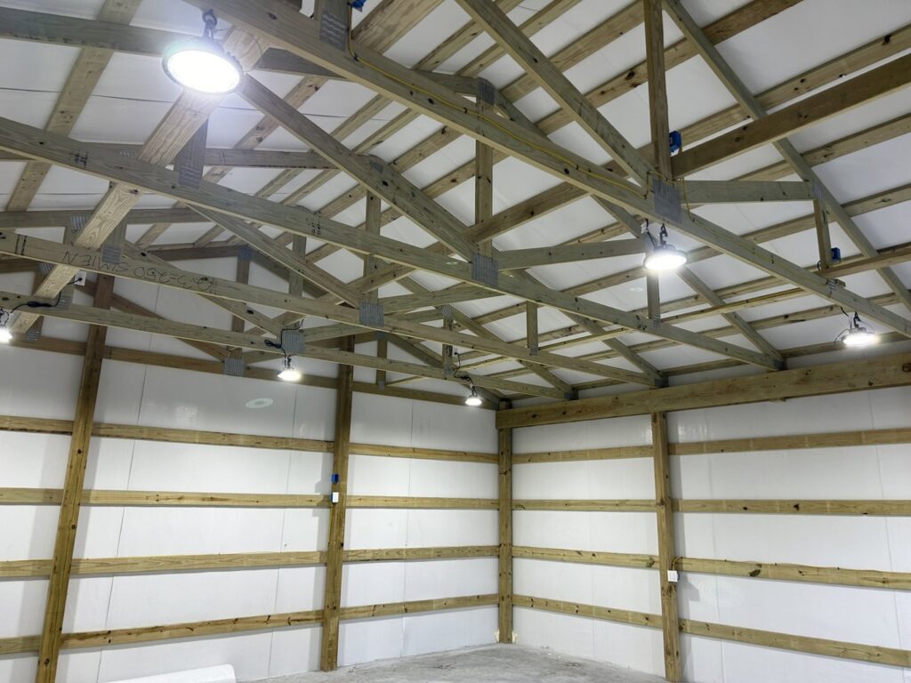 Commercial lighting and wiring installation on exposed trusses by Justin Benevage Electrical, LLC in Lake Charles, LA