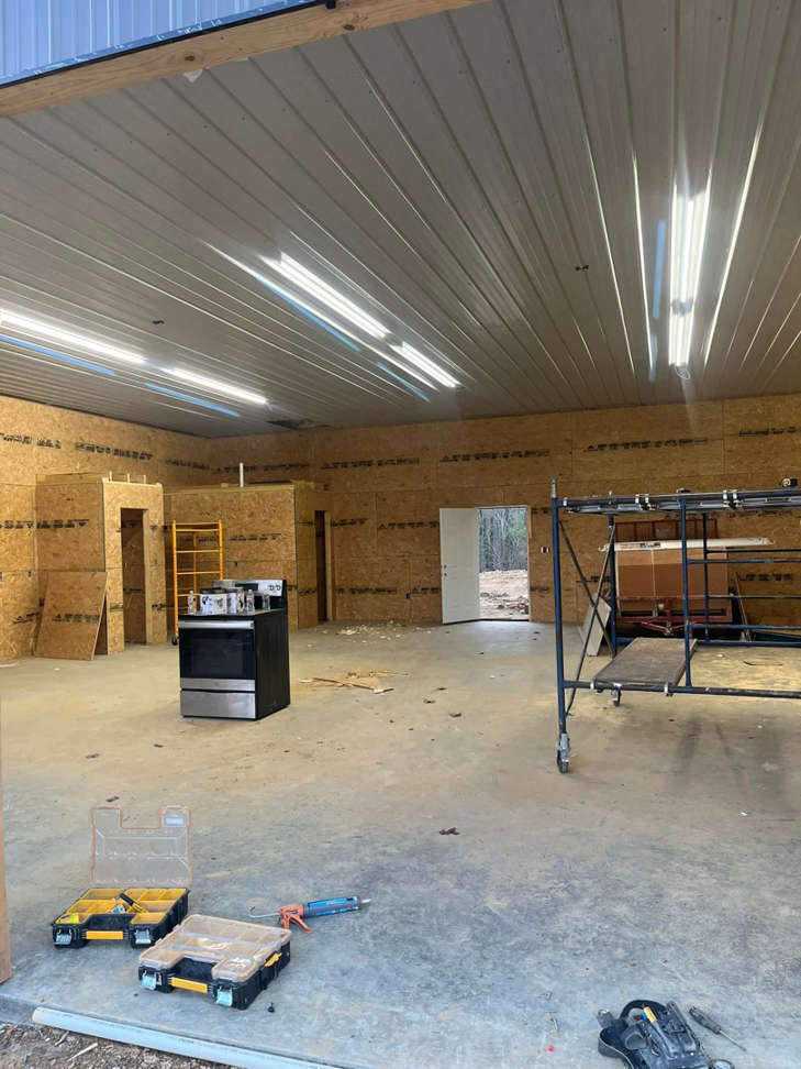 Commercial-style strip lighting installed in a large garage or workshop by JMD Electric, LLC in O'Fallon, MO.