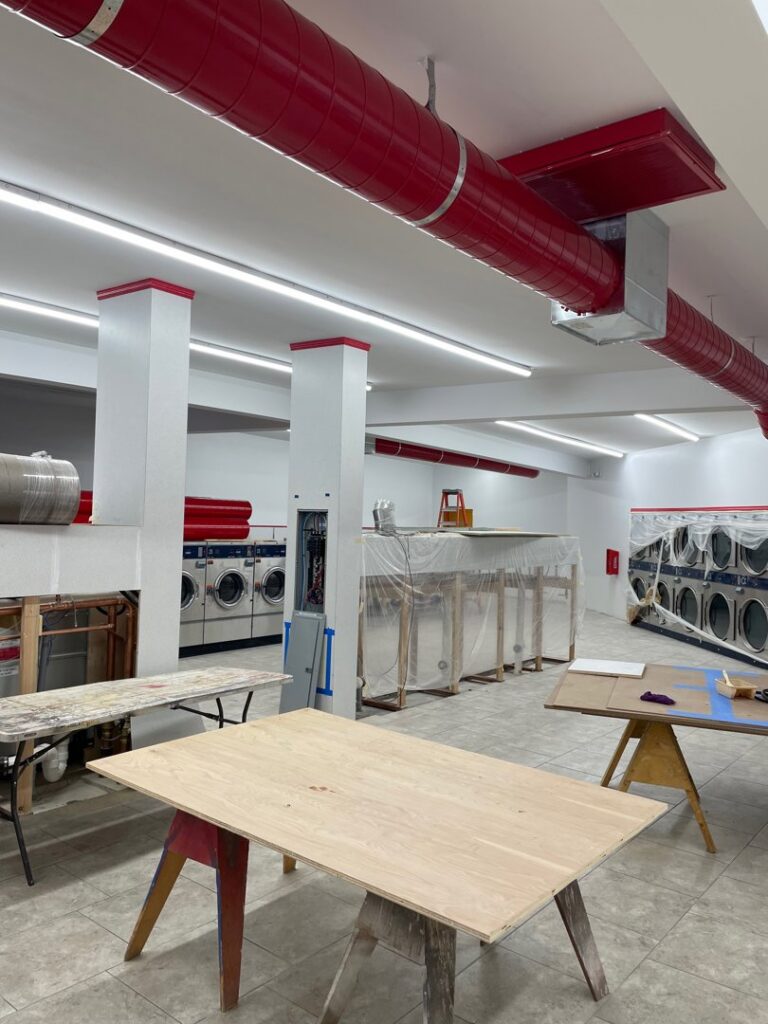 New fluorescent lighting installed in a commercial laundry room under construction by Industrial Edge Electrical in Gilbert, AZ.