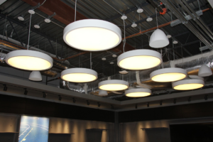 Commercial lighting installation featuring modern pendant and track lights by Partners Electrical Services in Houston, TX.