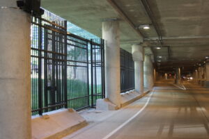 A commercial black metal fence installed along an underpass by Superior Custom Fence Inc. in Chicago, IL.