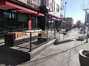 Commercial metal railing and fencing around an outdoor seating area installed by Ozark Fence in Lakewood, CO.