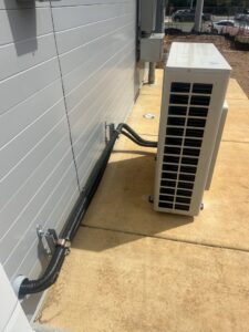 Outdoor mini-split condenser unit installed on a commercial building by That Air Conditioning Company LLC in Dothan, AL
