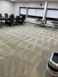 A large commercial office space with freshly cleaned carpet showing distinct patterns, serviced by Capital City Floor Care LLC in Columbus, OH.
