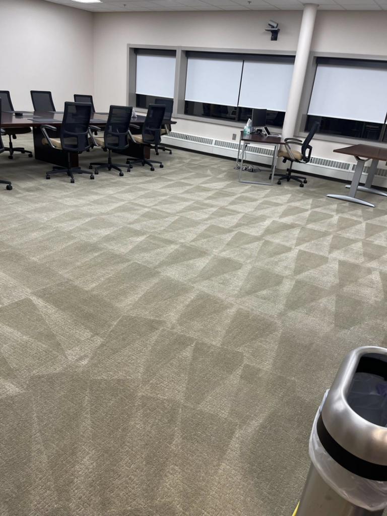 A large commercial office space with freshly cleaned carpet showing distinct patterns, serviced by Capital City Floor Care LLC in Columbus, OH.