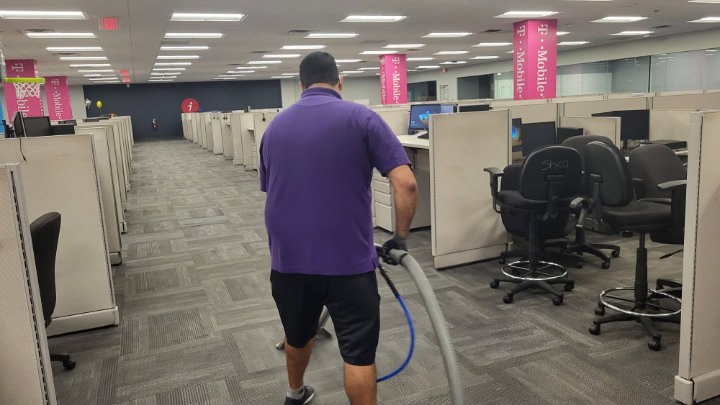 A technician cleaning carpet in a commercial office space for My Carpet Cleaner Nashville, TN