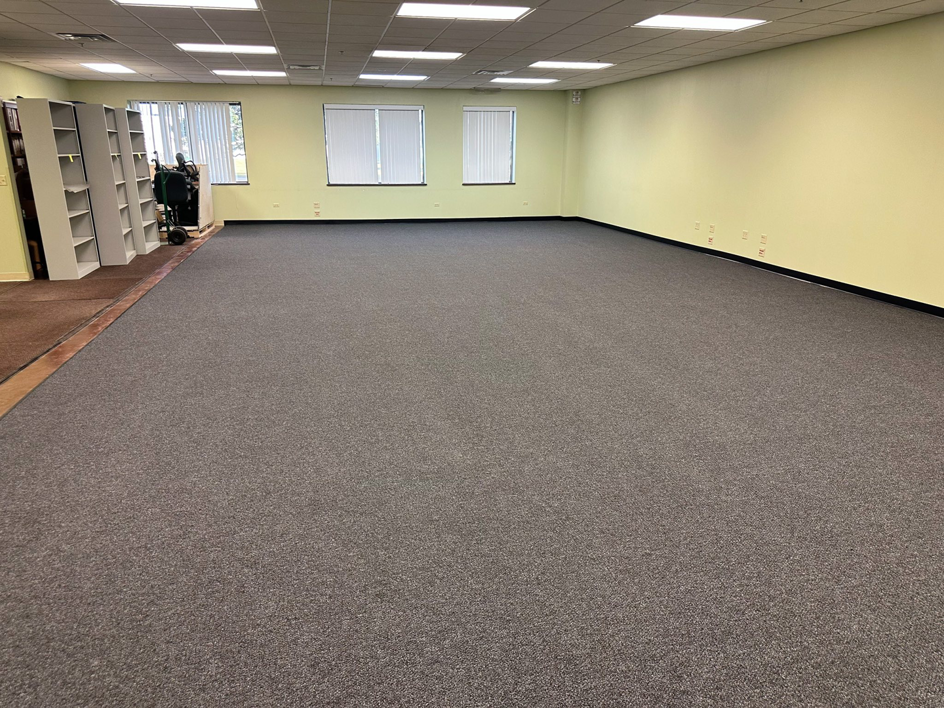 A large commercial office space with new grey carpet installed by Carpet Near Me in Services Available In.