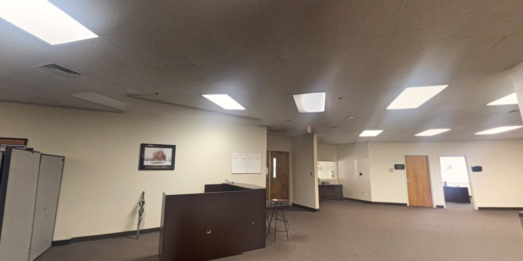 An empty commercial office space with new brown carpet installed by Carpet & Wood Floor Liquidators in Baltimore, MD.