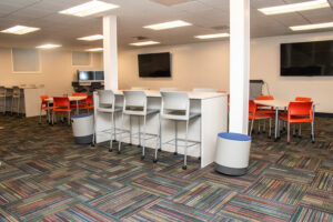 A spacious commercial office area featuring a colorful carpet tile installation by InVision Construction in Pearl, MS.