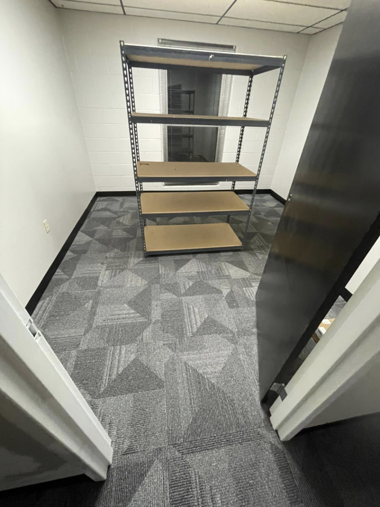 A small commercial office room with new patterned carpet tiles installed by A Step Above Flooring in Lexington, KY