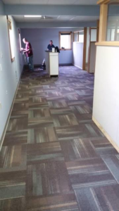 A commercial office space with new carpet tile flooring, a completed project by Flooring Authority, Inc. in Amsterdam, NY.