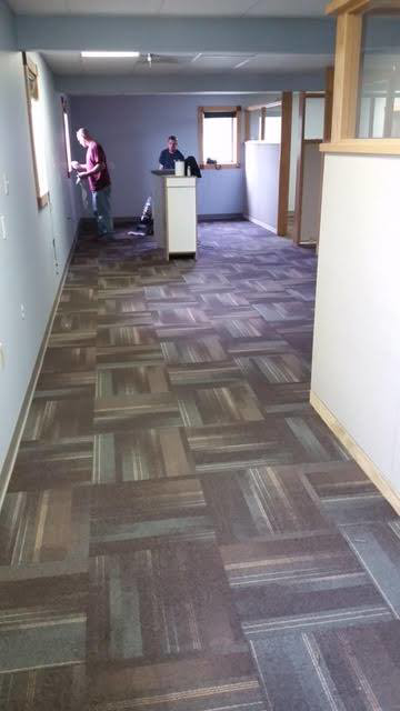 A commercial office space with new carpet tile flooring, a completed project by Flooring Authority, Inc. in Amsterdam, NY.