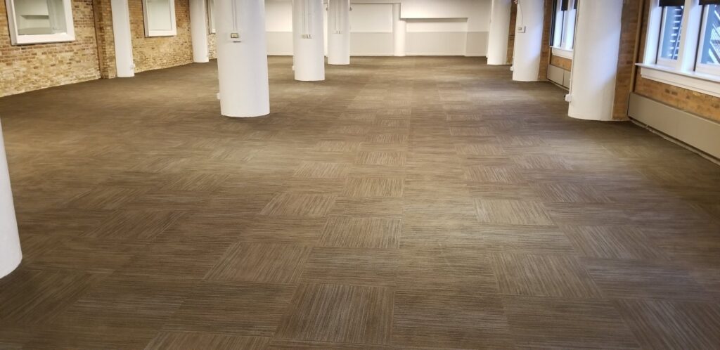 Clean commercial carpet tiles in a spacious office area, maintained by Advanced Floor Cleaning, Inc. in Elgin, IL