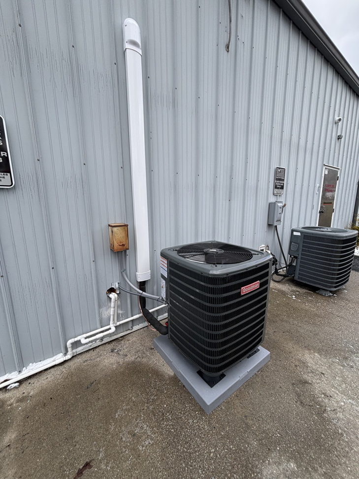 Two commercial outdoor AC condenser units installed by AAA Heating & Air Conditioning Service Inc. in Lexington, KY.