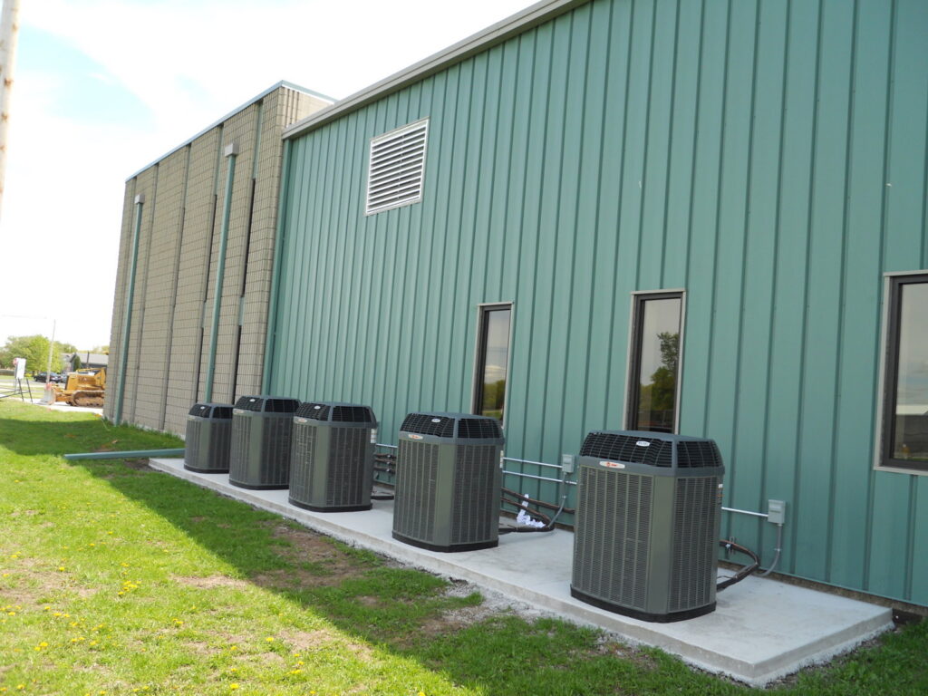 Five commercial outdoor AC condenser units installed by Advantage Mechanical, Inc. in Appleton, WI.