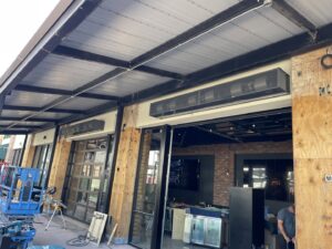 Installation of commercial outdoor heaters on a building exterior by Ernco Electric Inc. in Fresno, CA.