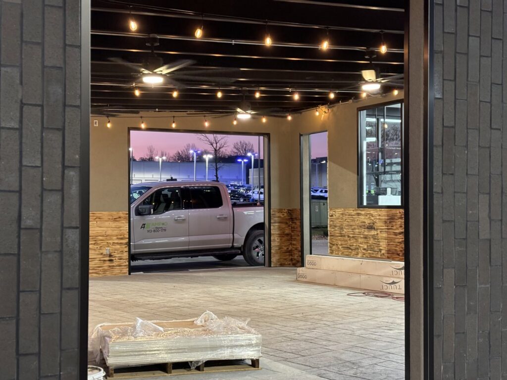 Commercial outdoor space with newly installed string lights and ceiling fans by Amped Electric in Virginia Beach, VA.