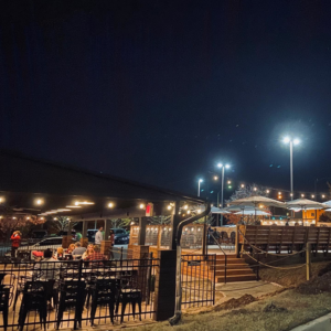 Commercial outdoor lighting and string lights installed by Natural State Electric LLC at a patio in Fayetteville, AR.