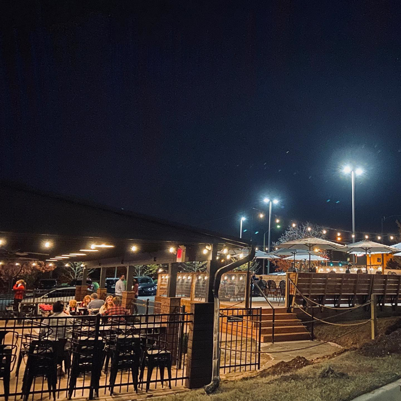 Commercial outdoor lighting and string lights installed by Natural State Electric LLC at a patio in Fayetteville, AR.
