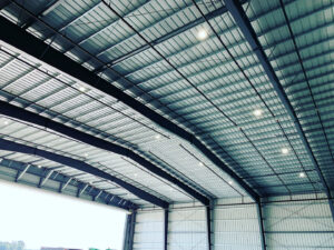 High ceiling of a large commercial building with numerous overhead lights installed by Harbour Electric in Wilmington, NC.