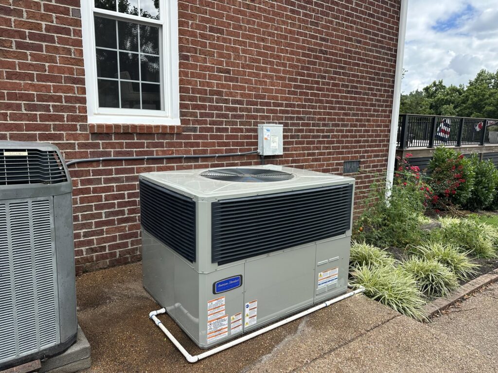 A large commercial package HVAC unit newly installed next to a brick building by Breeze Heating & Cooling Nashville in Nolensville, TN.