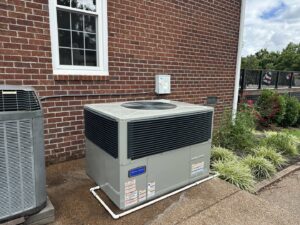 A large commercial package HVAC unit newly installed next to a brick building by Breeze Heating & Cooling Nashville in Nolensville, TN.