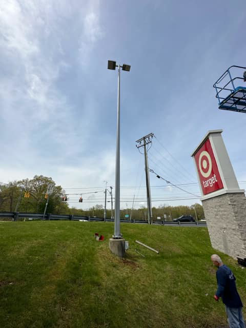 A tall commercial parking lot light pole with fixtures, ready for service by Lighting Services, Inc. in Waterbury, CT.
