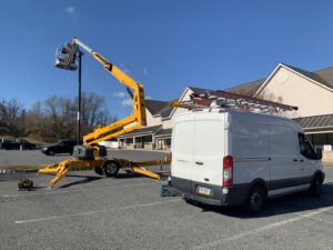 Commercial parking lot light repair using a boom lift by Civic Electric in Bethlehem, PA