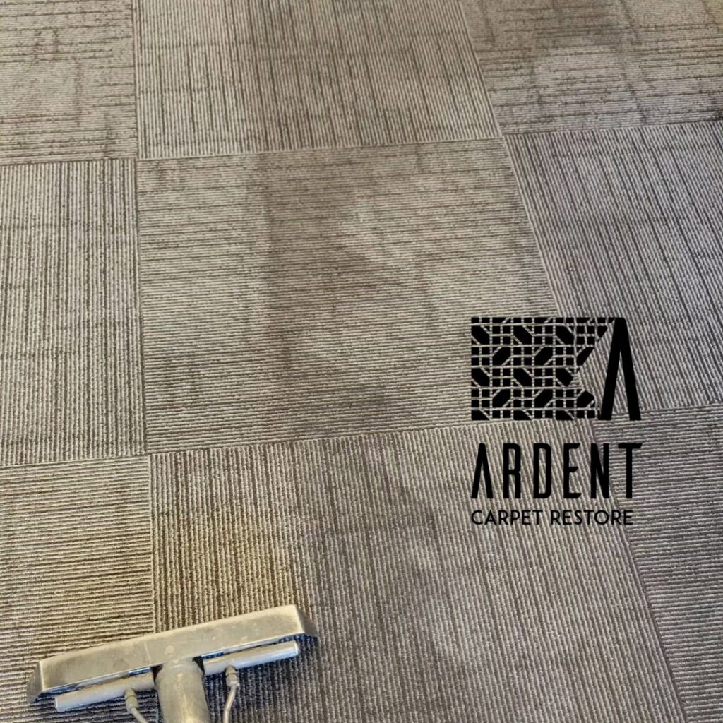 A carpet cleaning wand cleaning a patterned commercial carpet by Ardent Carpet Restore in Sacramento, CA.