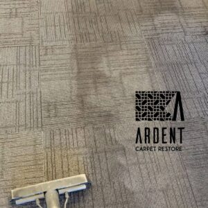 A carpet cleaning wand cleaning a patterned commercial carpet by Ardent Carpet Restore in Sacramento, CA.