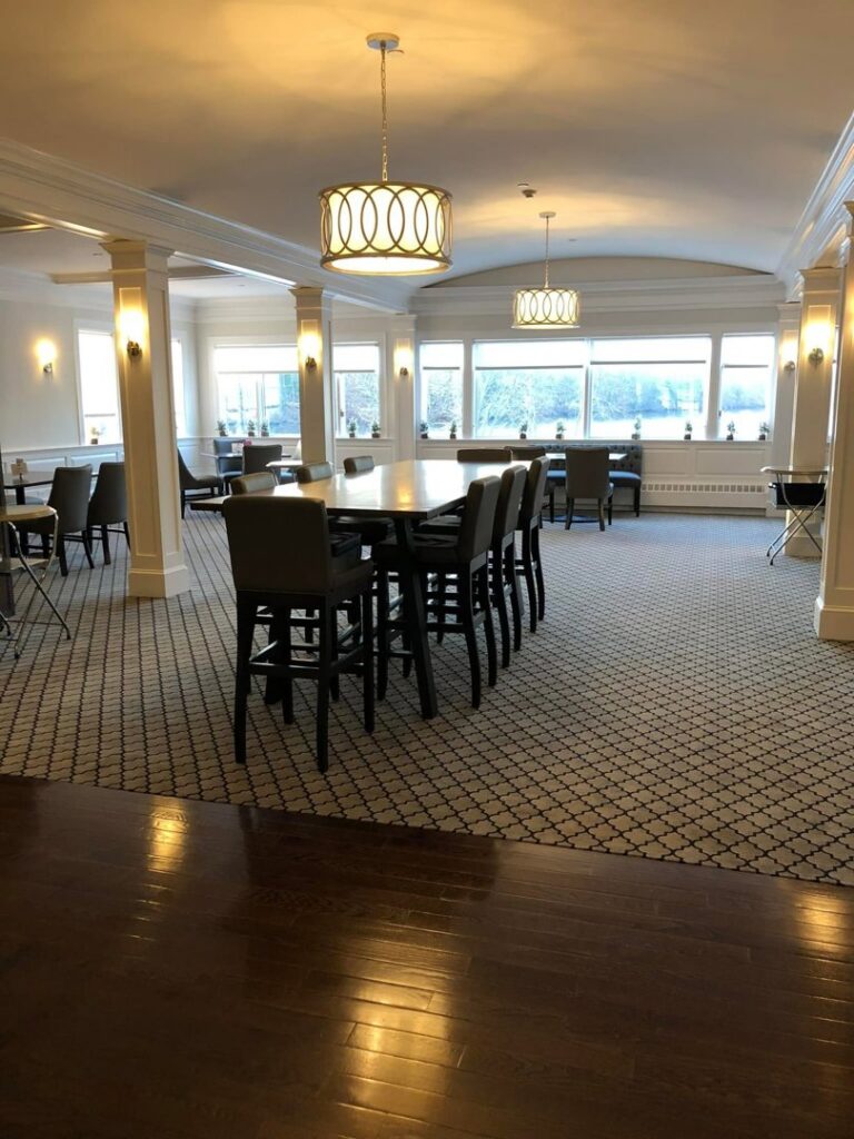 A commercial dining or meeting room with a newly installed patterned carpet by National Carpet and Flooring in Tyngsboro, MA.