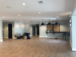 Commercial space with multiple pendant lights and recessed lighting by Empower Electric, LLC in Nashville, TN.