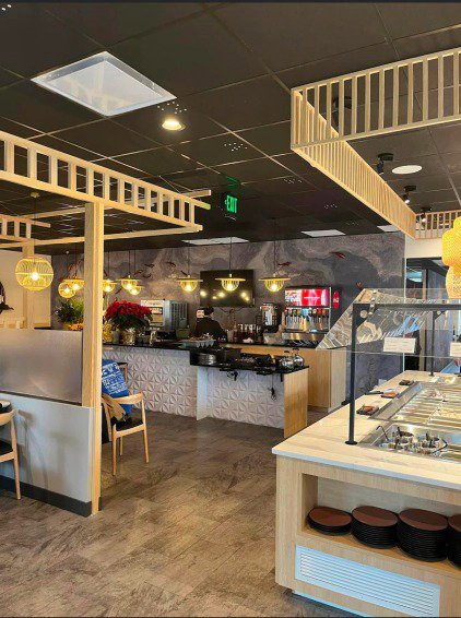 A commercial interior showcasing installed pendant and recessed lighting fixtures by Homestead Electric in Orem, UT.