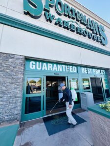 A Box Pest Control technician performing commercial pest control service at a Sportsman's Warehouse in Farmington, NM.