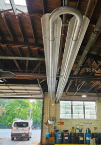 Commercial radiant tube heaters installed in a large building by Dixon's Heating & Air Conditioning, Inc. in Athens, IL