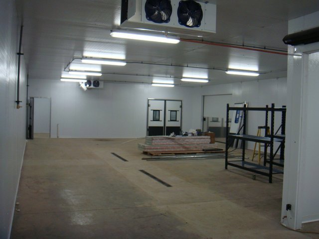 Interior of a large commercial refrigeration room with ceiling-mounted units installed by Benck Mechanical Inc in Somerset, WI.