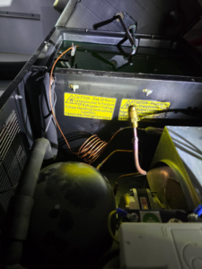 The interior components of a commercial refrigeration unit serviced by Proctor Mechanical & Refrigeration in West Des Moines, IA.