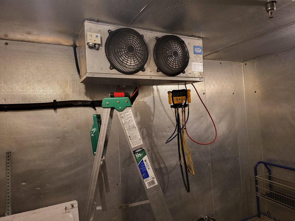 A commercial refrigeration unit being serviced with gauges connected by Santos Heating and Cooling in St Joseph, MO.