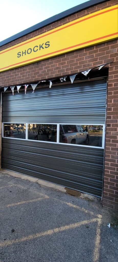 A newly installed commercial rolling door with windows by Universal Overhead And Garage Doors in Baltimore, MD.