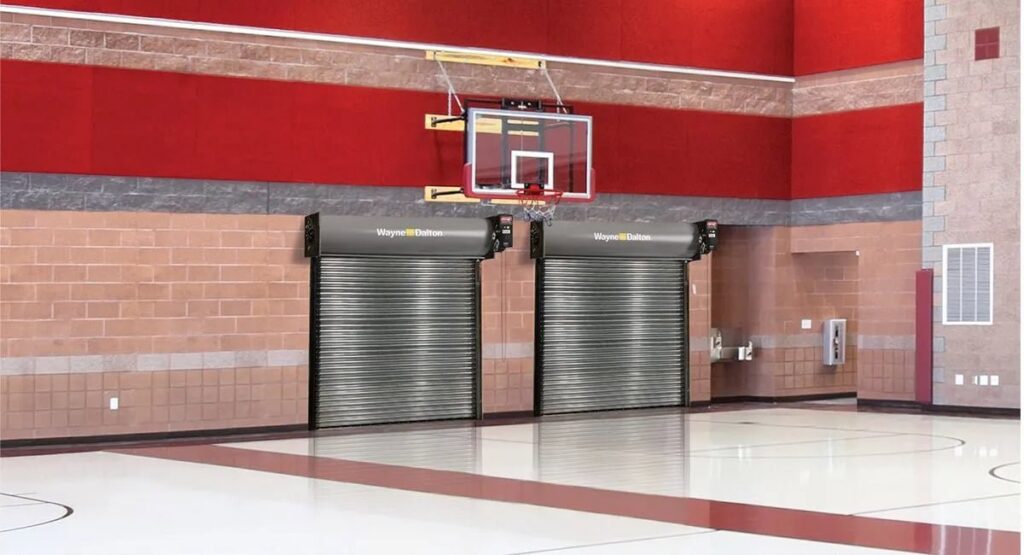 Two commercial rolling steel doors installed inside a gymnasium, a service provided by Overhead Doors Unlimited, LLC in Appleton, WI.